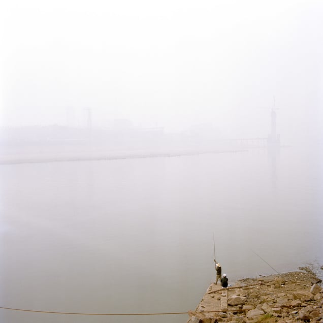 Fishermen in the polluted downtown area