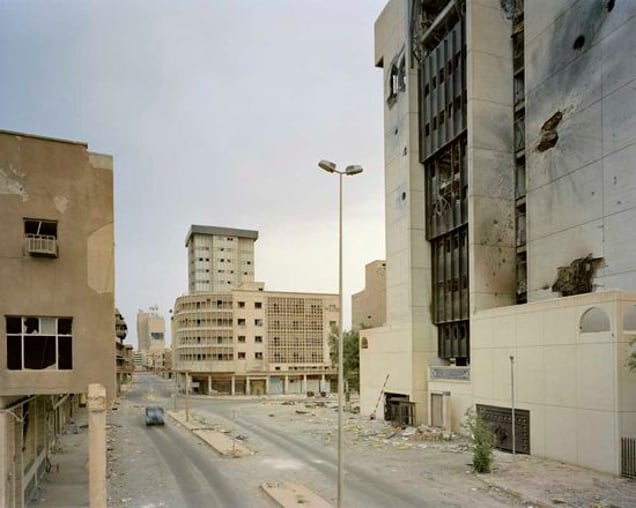 Rashid Street in Central Baghdad. The building on the right overlooks the bridge and was heavily damaged in the fighting. Baghdad 19-27 April 2003. From "Forensic Traces of War" © Simon Norfolk