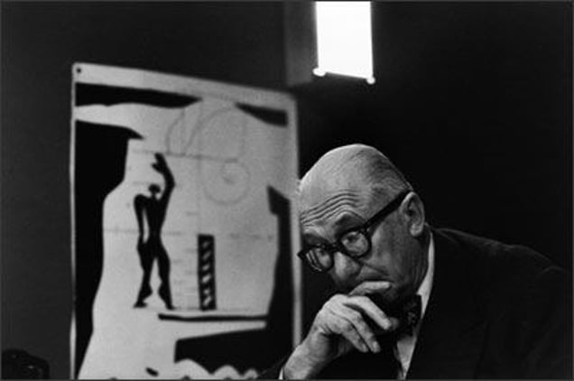 Le Corbusier, Paris, 1959. The architect in the private office of his studio, Atelier 35 S, built within a former monastery in the rue de Sèvres in Paris. In the background is the Modulor, a system of measurement used by Le Corbusier to achieve harmony in his architectural compositions. © René Burri / Magnum Photos