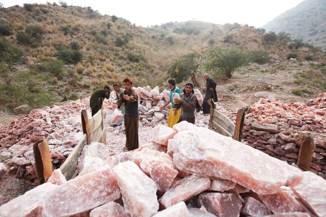 Salt miners loads a trailer with pink rock salt at the Kalabagh salt mine.