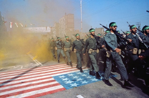 Ahvaz, Iran, February 1983. A parade commemorating the 4th anniversary of the Iranian Revolution. Islamic Revolutionary Guards (Pasdaran) marching over the American flag during the Iran-Iraq war. © Manoocher Deghati