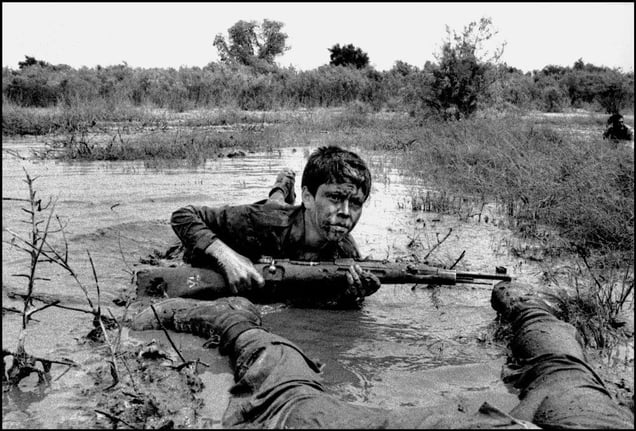 A thirteen year old Basij fighter advances on the southern front of Susangard Iraq-Iran war. Susangard, IRAN - March 1980
© Copyright 1979-2009 Alfred Yaghobzadeh. All rights reserved.