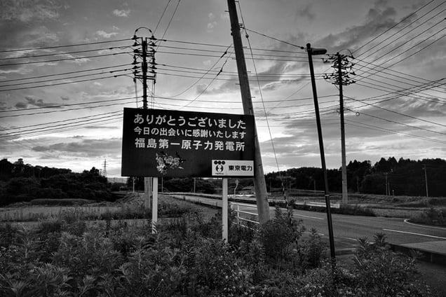 The roadsign put up by TEPCO at the exit of Fukushima Daiichi nuclear plant reads: "Thank you for your visit, it was great to meet you, hope to see you soon. -TOKYO DENRYOKU (TEPCO)", from the series Fukushima "No Go" Zone, © Pierpaolo Mittica.