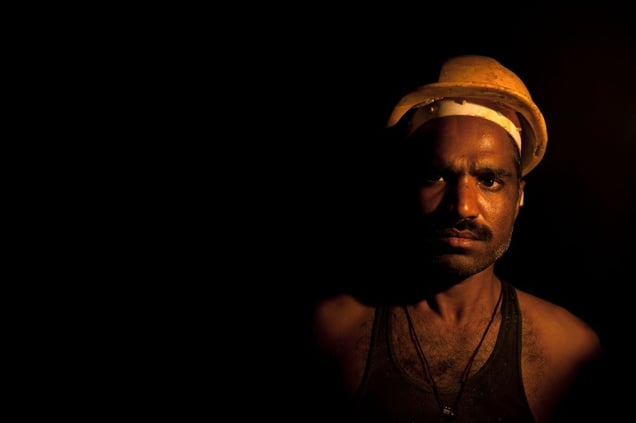 A salt miner is highlighted in the darkness by the light of his gas-fueled lantern  the Warcha salt mine.
