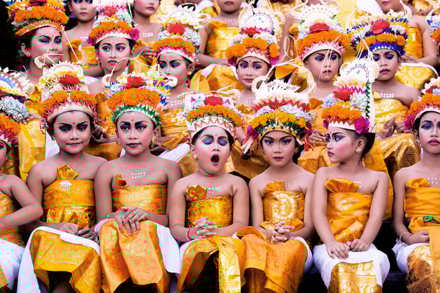 Image was taken in Bali during Melasti Festival. This festival is conducted once a year in conjunction with Nyepi or Silent Day. These young girls wait for their turn to perform. They looked stunning with their bright coloured costumes and heavy make-up on, however the expression on each of the girls' faces (especially the yawning girl) gives this image an extra "ummpph"