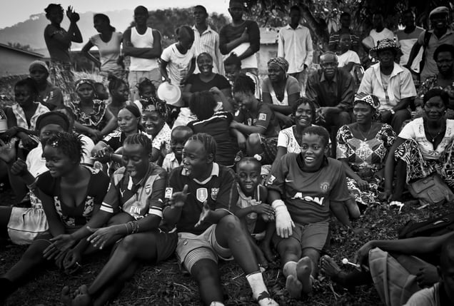 Residents of Freetown cheer for the Ebola Survivors Football Club on a field in the city of Kenema, Sierra Leone, 21 April 2015.