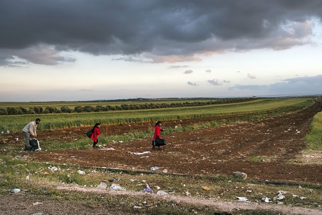 A Syrian man and his two daughters after entering Jordan at an unofficial border crossing. Sharjarh, Jordan, April 10, 2013. © Lynsey Addario / Getty Images Reportage for The New York Times