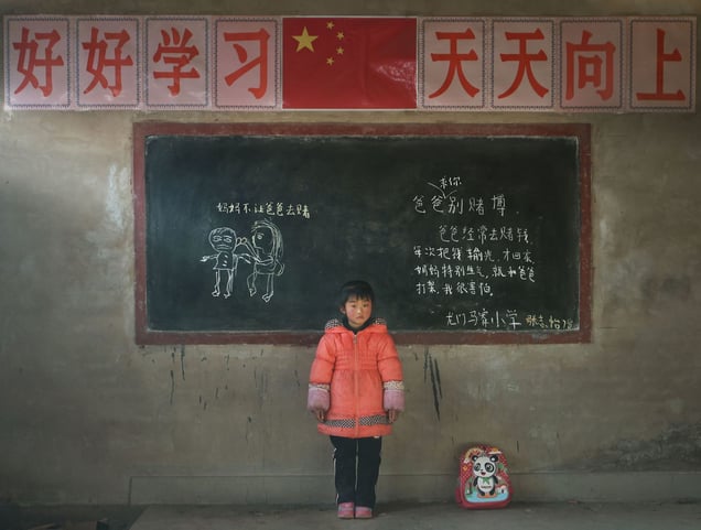 "Zhang Zhiyii, Gansu province. She wrote down: Dad lost money gambling, He also severely hit mother".  From the Series "Left-behind Children"