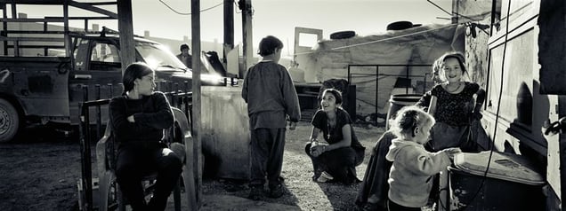 In front of Dionysia's shack. Dionysia's daughter Marina to the left. Nea Zoi, Aspropyrgos, Attica. © Joakim Eskildsen. Courtesy of Steidl.