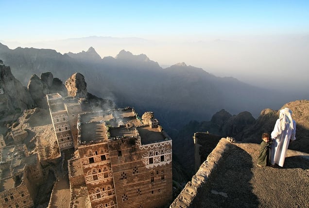 Shugruf, Yemen: In the early morning father and son are standing on the platform of their palace, looking at their small town awakening. © Matjaz Krivic