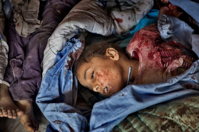 A girl lies dead in a makeshift morgue, part of a field hospital in the Shaar district of Aleppo on February 10, 2013. © Nish Nalbandian