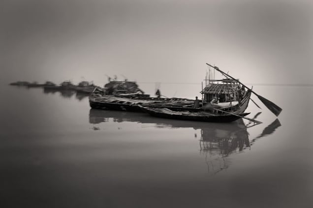 Golpata collectors settle after work in the middle of the river near Sunderban. Increased salinity from shrimp cultivation has forced traditional fishermen to abandon their families for months at a time, and seek a long-term livelihood in Sunderban. Sunderban, Satkhira. © Munem Wasif/VU'