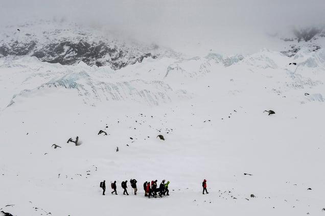 Rescuers carry an injured person to a medical tent after the avalanche hit theEverest Base Camp. Nepal, 25 April 2015.