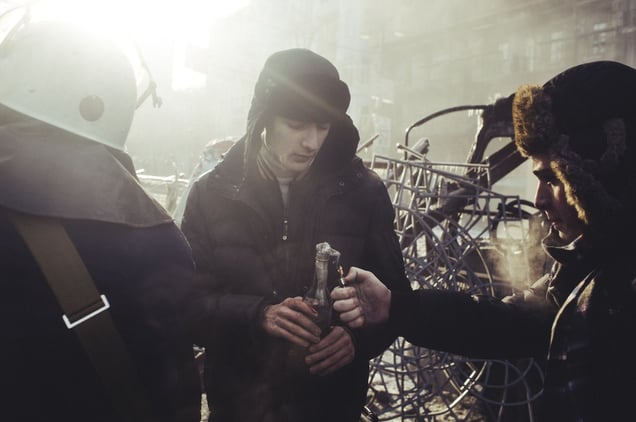A protester  set fire a Molotov cocktail during clashes with police in central Kiev, Jan. 20, 2014.