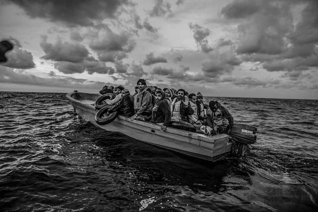A boat with a broken engine carrying 22 migrants is spotted drifting off the coast Libya by rescuers