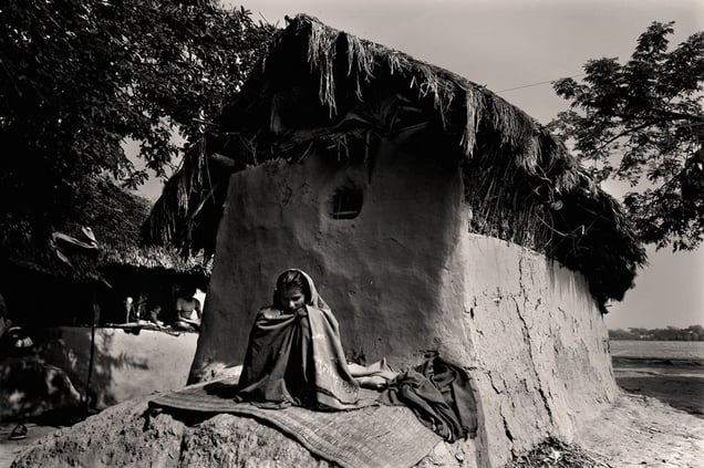 Durgabadda Mondol (50) is the sole earner of the family. He and his family have been suffering from numerous diseases during the past few months. His daughter-in-law, unwell, sits outside in the sun. Chuna, Satkhira. © Munem Wasif/VU'