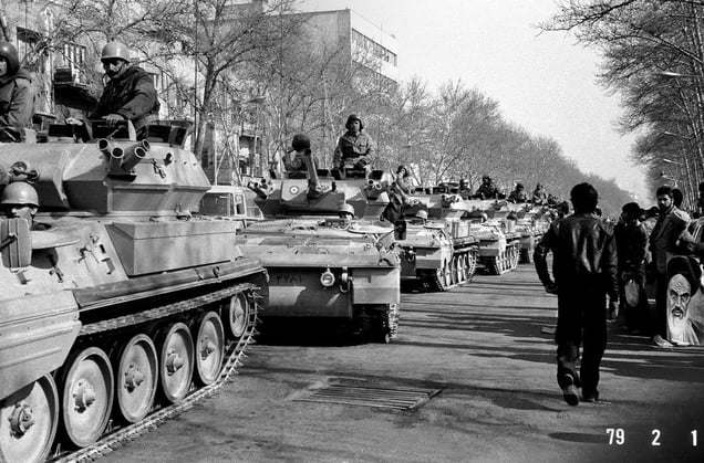 The Shahs army tank units parading down Shahreza Avenue. Following the success of the revolution, this road was renamed "Enghelab" (Revolution) Avenue. Faced with mounting threats, the Shah declared martial law in September 1978 and imprisoned many suspected opposition leaders and protesters. Tehran, IRAN - February 1, 1979
© Copyright 1979-2009 Alfred Yaghobzadeh. All rights reserved.
