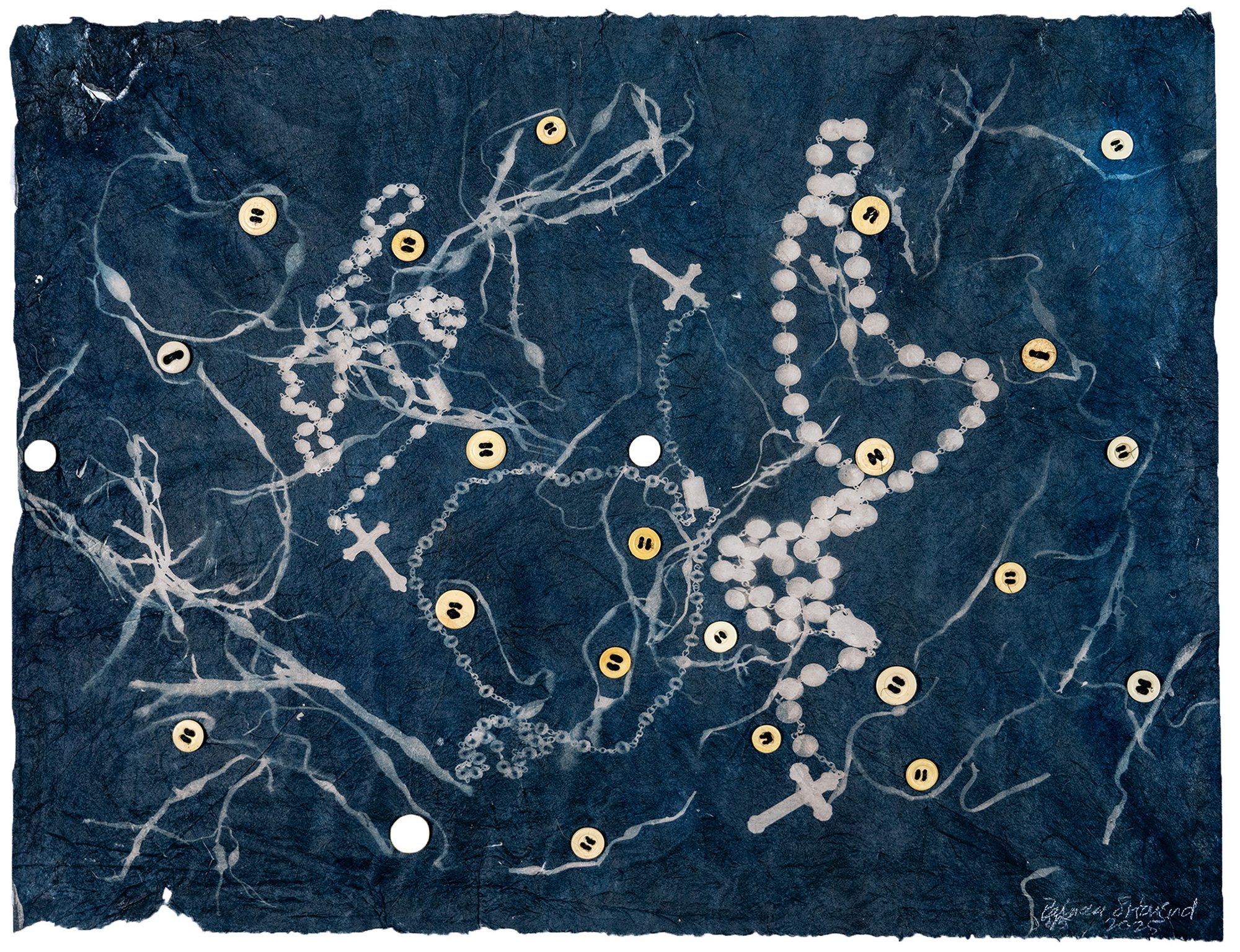 This is an image made from rosaries and pieces of seaweed. It was made by the cyanotype process onto semi-transparent, hand made paper. Cyanotype is a process developed in the 1840s, the same time period that I am reflecting upon. It has been toned with black tea and bone buttons are attached. The tea tones the brightness of the blue cyanotype to a more subdued brown and blue. The buttons are antique, from the 1800s. The paper is ripped and torn in places and the edges of the paper are deckled. The rosaries represent the prevalent religion in Ireland, Catholicism and the sea weed the ever-present ocean or sea. Both are objects that might remain after ancestors have left this country. © Patricia Howard