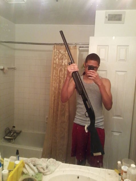 Sharrod's selfie (rifle). From the series "I slowly watched him disappear" © Jason Hanasik