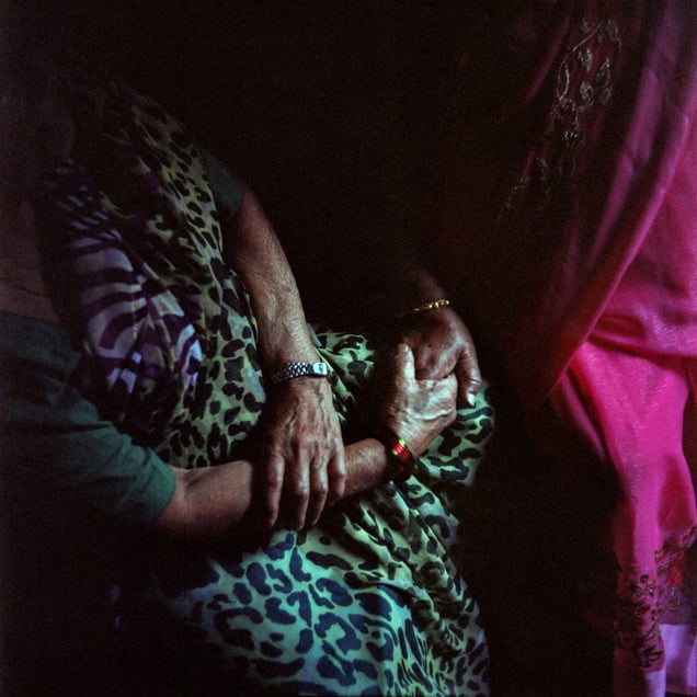 Two octogenarian mitinis hold hands, their lives intertwined through decades. Despite their age and mobility challenges, they finally reunited after over five years. As they spoke, they marveled at how everything around them had changed, yet their bond remained constant and unwavering.