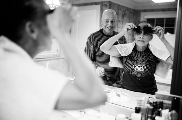 Late one evening, Howie cuts Laurel’s hair, knowing that it will start falling out on its own in the coming weeks as a side effect from the chemotherapy. Chappaqua, New York. February 2013 © Nancy Borowick