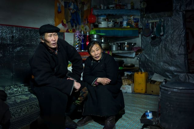 Reindeer herders in their winter log cabin.