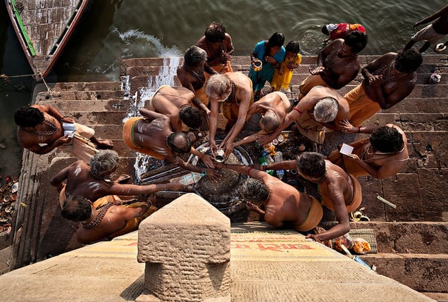 Varanasi, India: The early morning ritual on the shores of the sacred river of Ganges. Gift bearing to Shiva's lingam, hoping that the young girl will become fertile. © Matjaz Krivic