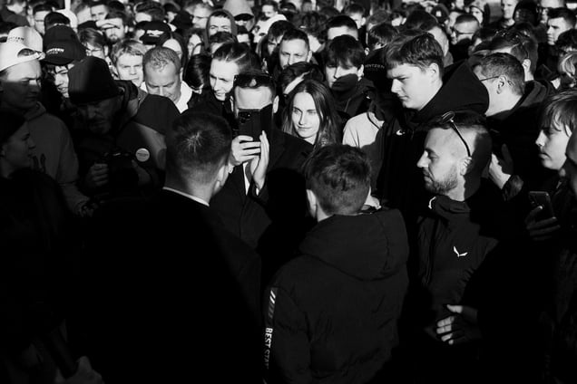 A young woman is closely observing a presidential candidate during the election campaign in the Spring 2025.