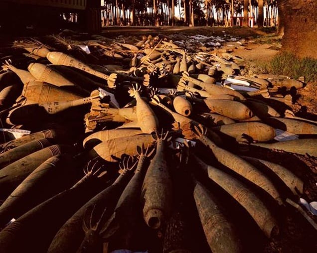 Abandoned mortar shells in a date grove in Atifya, northern Baghdad. Baghdad 19-27 April 2003. From "Forensic Traces of War" © Simon Norfolk