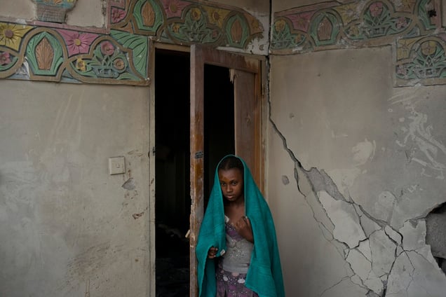 A Yemeni girl who was injured in a Saudi coalition airstrike stand in her home on July 16, 2015 in Sana'a, Yemen. The strike killed nearly thirty people, most from the same family. © Alex Potter