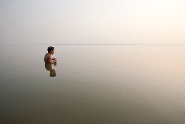 Varanasi, India: A worshipper during his everyday cleansing ritual in the sacred river of Ganges. © Matjaz Krivic