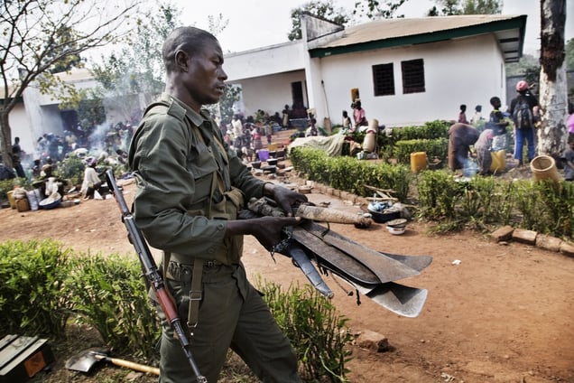 As displaced persons entered the compound, their machetes were confiscated by FOMAC troops. December 6, 2013. © Marcus Bleasdale / Human Rights Watch / National Geographic Magazine