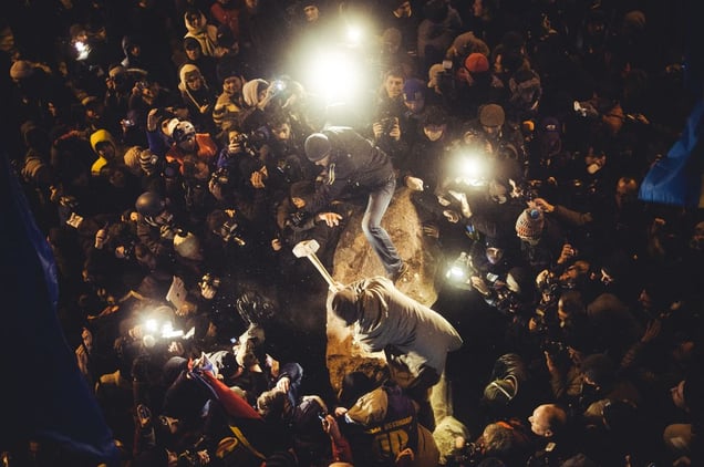 Anti-government protesters beat the statue of Vladimir Lenin with a sledgehammers in KIev, Ukraine, December 8, 2013.