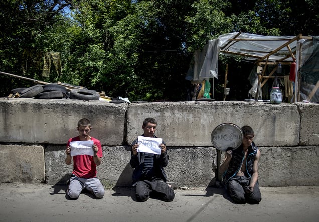 Locals suspected in looting arrested by rebels at a checkpoint near the city of Luhansk