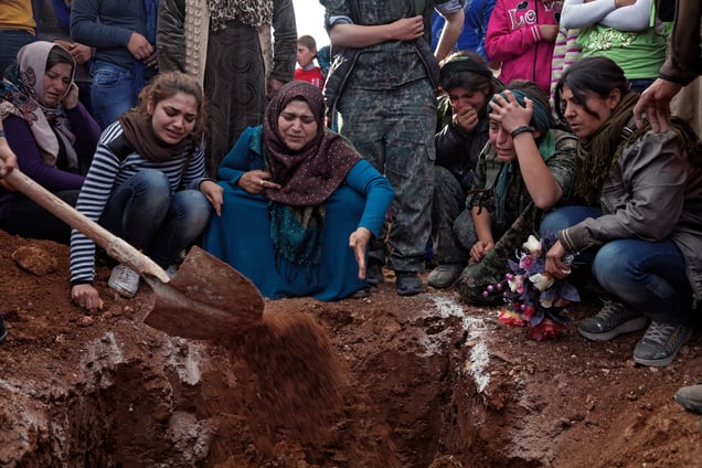 At a cemetery in Kobane, Syria, on 14 April, 2015, families and friends mourn around the grave of Ageri, a Kurdish female fighter who was killed during clashes with the Islamic State in Eastern frontline of Kobane, Syria.