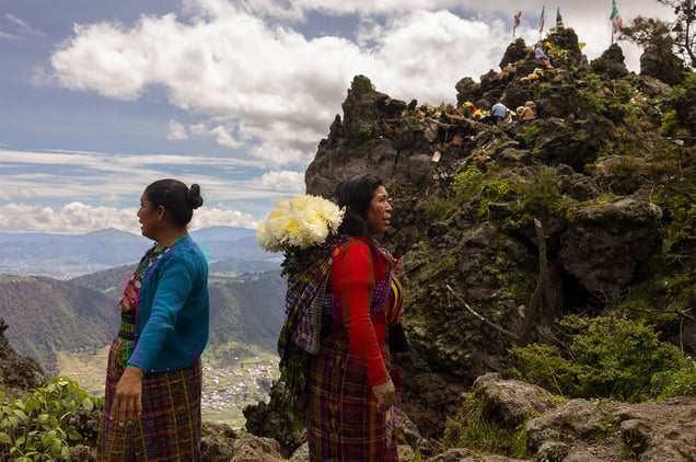 Locals on the Almolonga volcano, also called Cerro Quemado, in Guatemala. The ancient Maya believed that volcanoes were holy places where the Gods and spirits resided. Cerro Quemado is considered one of the best places to get close to the Gods. Thats why people come from all over the region to pray and perform ceremonies, bringing flowers and sometimes food and alcohol to leave as offerings to God and the ancestors. Some people also believe that Juan Noj, a supernatural Maya being lives in the volcano.