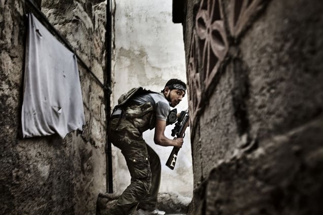 2nd Prize Spot News Stories © Fabio Bucciarelli, Italy, Agence France-Presse.  10 October 2012, Aleppo, Syria. A Free Syrian Army fighter takes up a position during clashes against government forces in the Sulemain Halabi district.