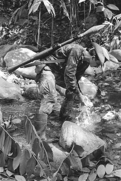 Serrania de San Lucas-Boliviar. A guerlla from the ELN (the National Liberation Army) rests on the shores of the Santo Domingo river. Since 1986 this armed group has caused spills of millions of barrels of oil across Colombian rivers and forests. 1995 © Jesus Abad Colorado, courtesy of Prix Pictet 2008