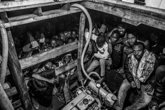 Migrants packed in to the hold of a large wooden boat