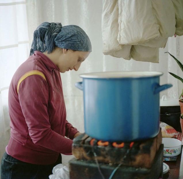 Young mother of three cooking dinner