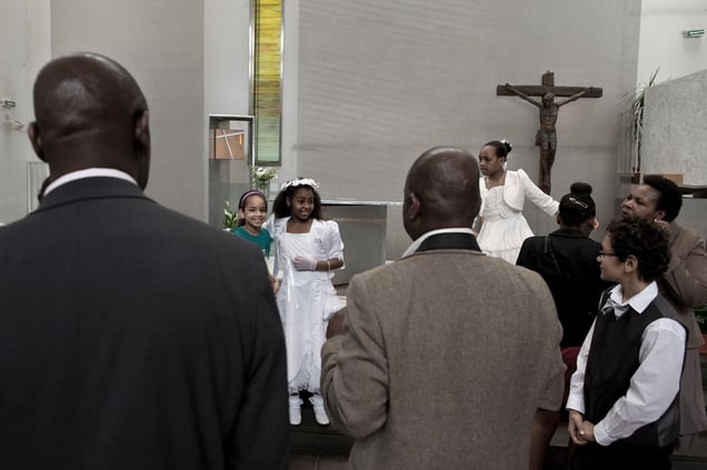 At the end of the Mass in the local church. Christianity is the third religion of the neighborhood, symbol of his evolution. Within the church is living more than 50 nationalities. The Caribbean Community is one of the most important. © Hugo Aymar
