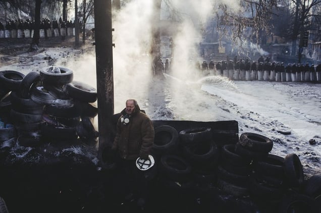 A man stands near barricade on Hryshevskoho street early in the morning. Kyiv, Jan. 27, 2014.