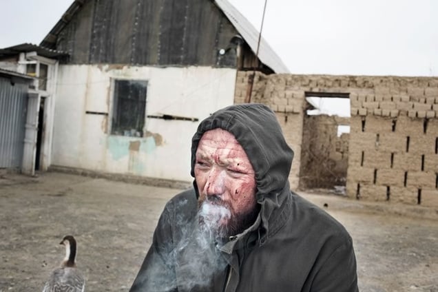 Kostya smoking after the ritual.
From the series Apashka by © Pavel Prokopchik