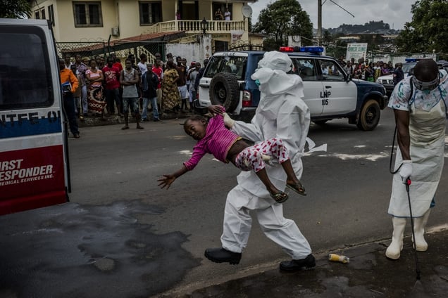 Monrovia, Liberia, August 31, 2014. Esther Doryen (5) being carried to an ambulance prior to being taken to the Ebola Treatment Center run by Doctors Without Borders. One week later she passed away. © Daniel Berehulak / Getty Images Reportage / The New York Times