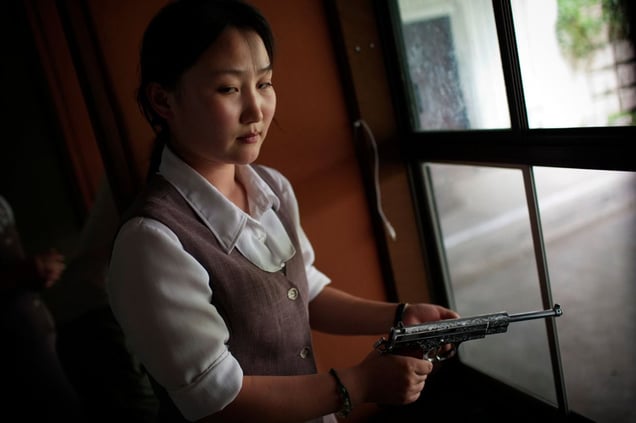 A North Korean woman loads a pistol for firing practice in Pyongyang, North Korea on August 18th, 2007.