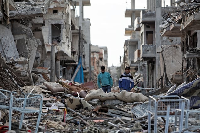 Kurdish boys among destroyed buildings in Kobane on 2 April, 2015.