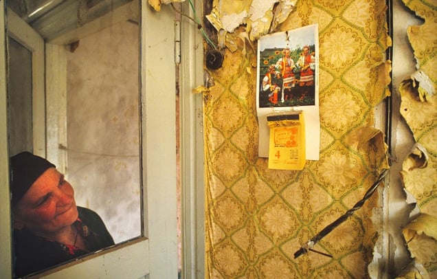 Chernobyl Exclusion Zone, Ukraine, 1993. A former resident returns to her home in Stechanka to find it has been vandalized except for a calendar marking the day of the evacuation, May 4, 1986.