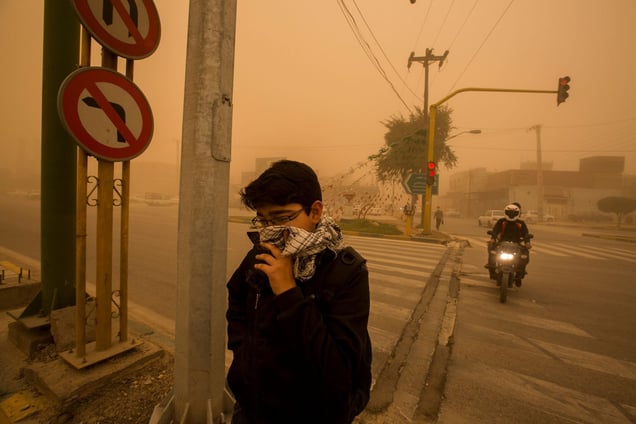 Silent Death, 2015. A boy covers his mouth to protect himself from pollution. On the streets of Ahvaz, one of the world's most polluted cities.