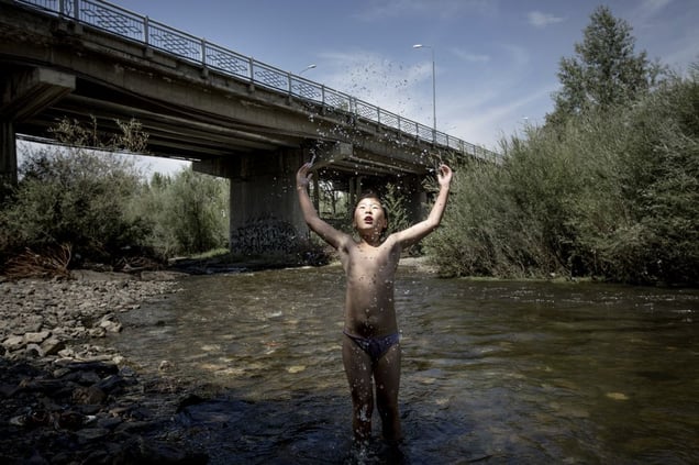 10-year-old Khulan playing in the polluted Tuul river.