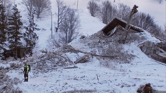 Farindola, Italy (2017).  A rescuer stands by what was left of the Hotel Rigopiano after the avalanche.